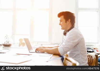 Young businessman in office. Young businessman working in office