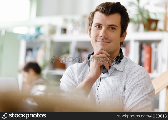 Young businessman in office. Young businessman working in office