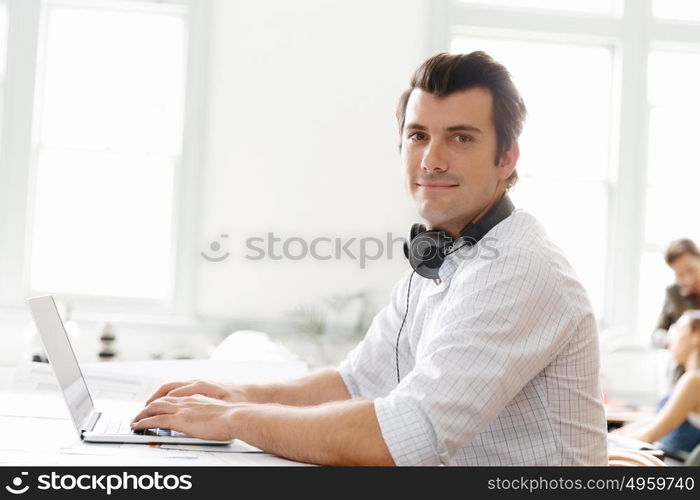 Young businessman in office. Young businessman working in office