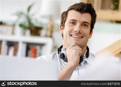 Young businessman in office. Young businessman working in office