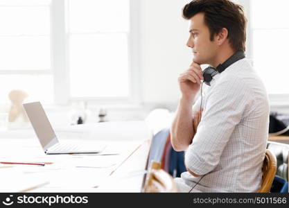 Young businessman in office. Young businessman working in office