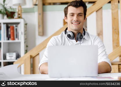 Young businessman in office. Young businessman working in office