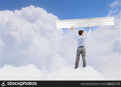 Young businessman in suit measuring ruler benefit. Man with scale