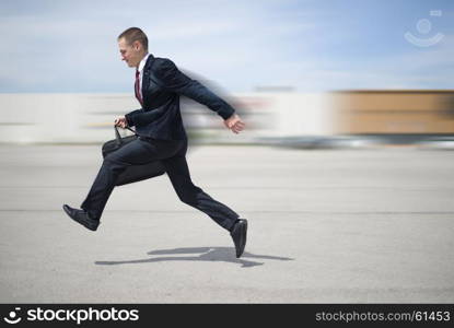 young businessman in suit. young businessman in a suit and with a briefcase running