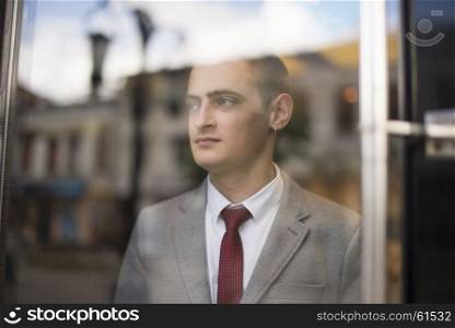 young businessman in suit. young businessman in suit standing and looking