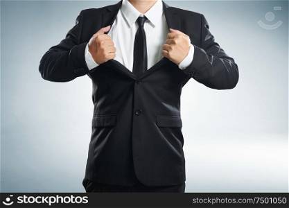 young businessman in superhero action with black suit