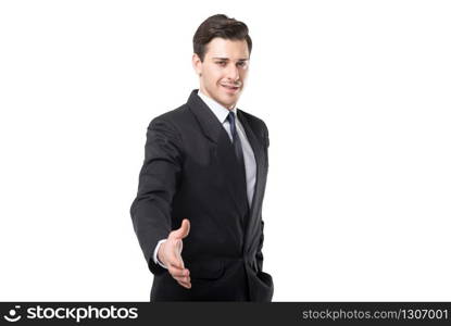 Young businessman in tie and black suit extends his hand, isolated on white background