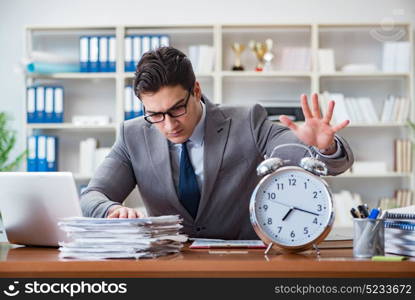 Young businessman in time management concept