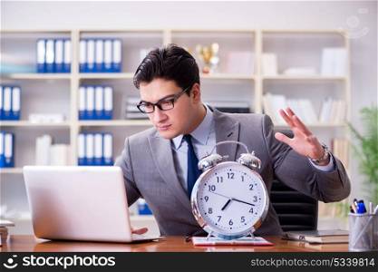 Young businessman in time management concept