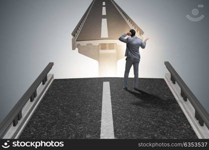 Young businessman in uncertainty concept with bridge