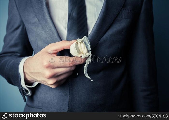 Young businessman is holding a garlic