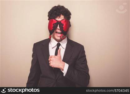 Young businessman is wearing a sexy bra on his face