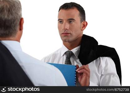 Young businessman listening to a senior colleague