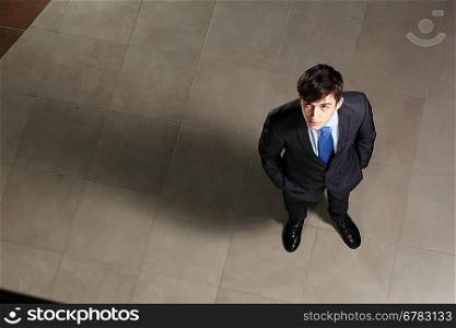Young businessman looking above