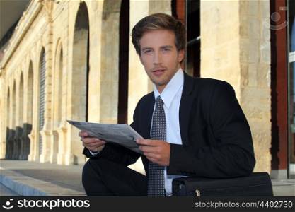 Young businessman looking at a paper
