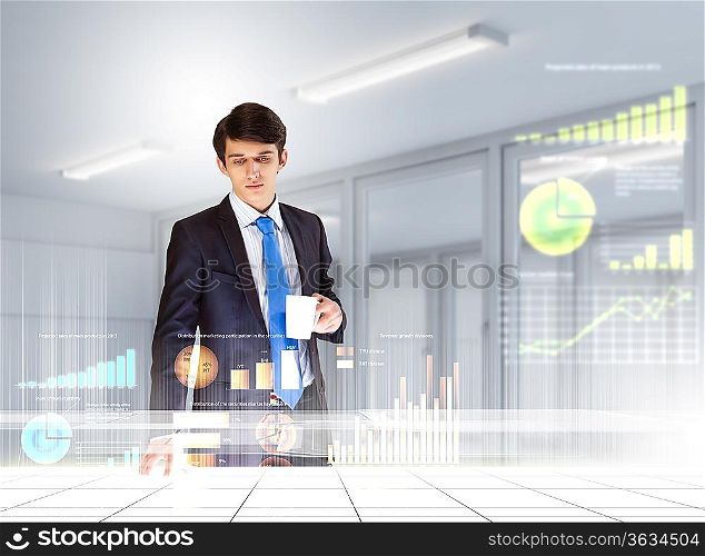 young businessman looking at graph of high-tech image