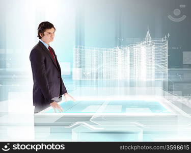 young businessman looking at high-tech image of building model