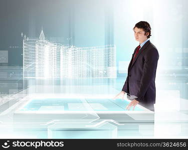 young businessman looking at high-tech image of building model