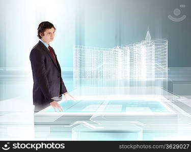 young businessman looking at high-tech image of building model