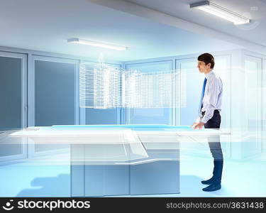 young businessman looking at high-tech image of building model