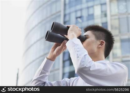Young Businessman Looking Through Binoculars