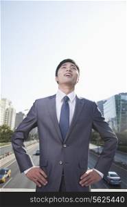 Young Businessman Looking Up