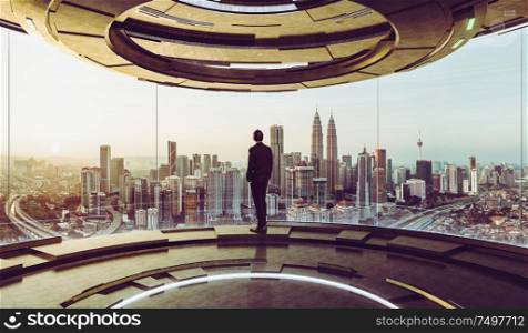 Young businessman looks out city outside from high-tech control room . Mixed media .