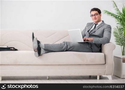Young businessman lying on the sofa