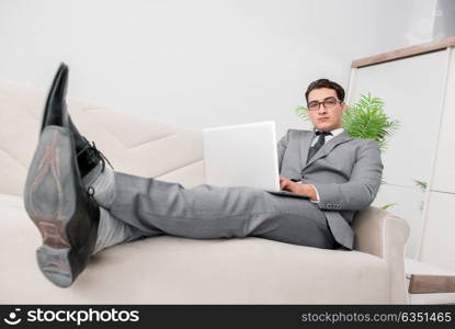 Young businessman lying on the sofa