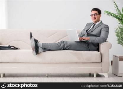 Young businessman lying on the sofa