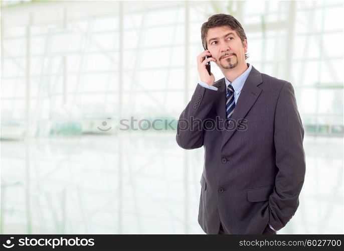 young businessman on the phone, at the office