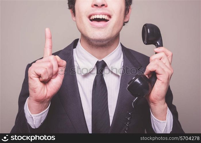 Young businessman on the phone gets a bright idea
