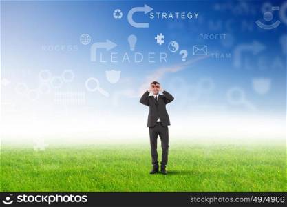 Young businessman outdoor with business symbols on the sky background