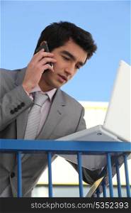 Young businessman outside an office building