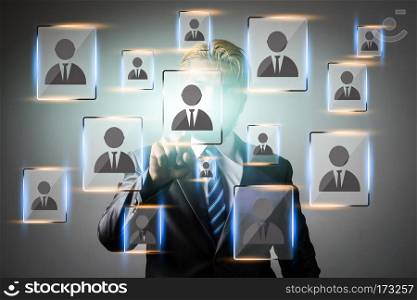 Young businessman pointing digital people icon network applicat. Young businessman pointing digital people icon network application on the screen