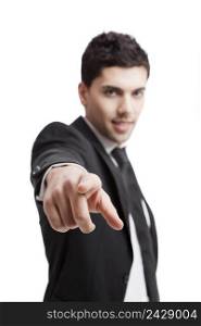 Young businessman pointing to you, isolated over a white background 