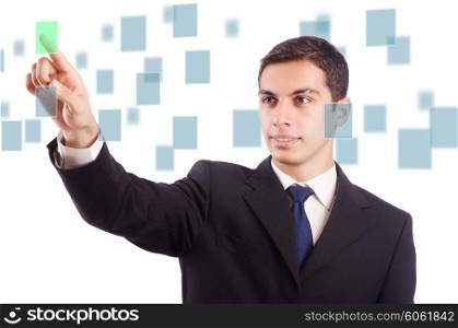 Young businessman pressing virtual buttons