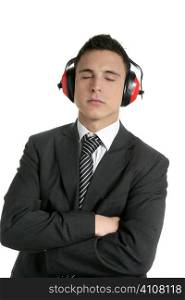 Young businessman protecting ears from noise with safety headphones