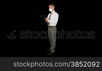 Young businessman, protective glasses and mask taking notes, against black