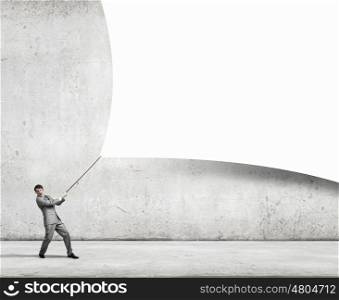 Young businessman pulling blank banner. Place for text. Place your ad