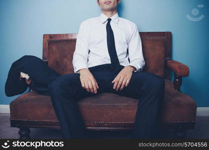 Young businessman relaxing on a sofa