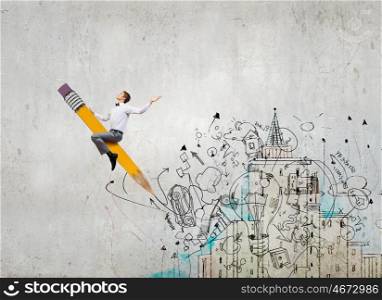 Young businessman riding pencil and business sketches at background. Man ride pencil