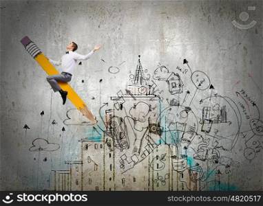 Young businessman riding pencil and business sketches at background. Man ride pencil