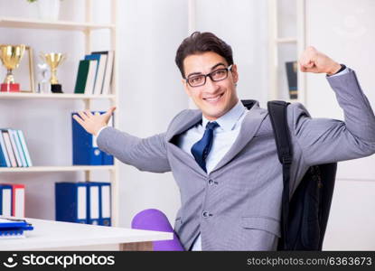 Young businessman rushing to sports gym during break