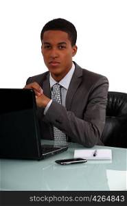 Young businessman sat at his desk
