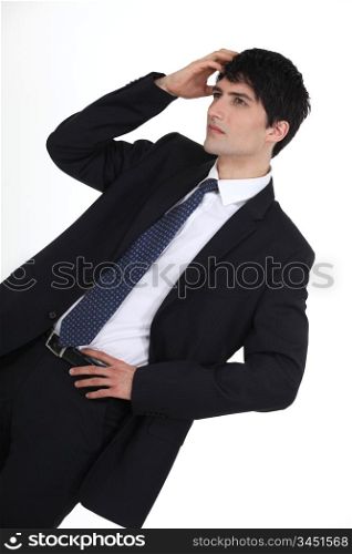 Young businessman scratching head