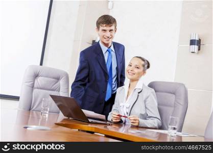 Young businessman showing lady boss business documents. Office work moments