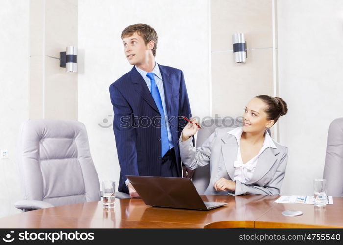 Young businessman showing lady boss business documents. Office work moments