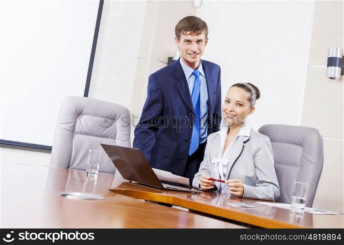Young businessman showing lady boss business documents. Office work moments