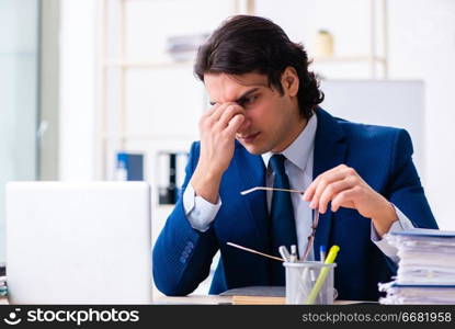 Young businessman sitting and working in the office